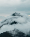 Mountain peak partially covered by clouds in Mount Fuego, Guatemala.