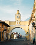 Architectural landmark with clock tower in a city street at dawn, in Antigua, Guatemala.