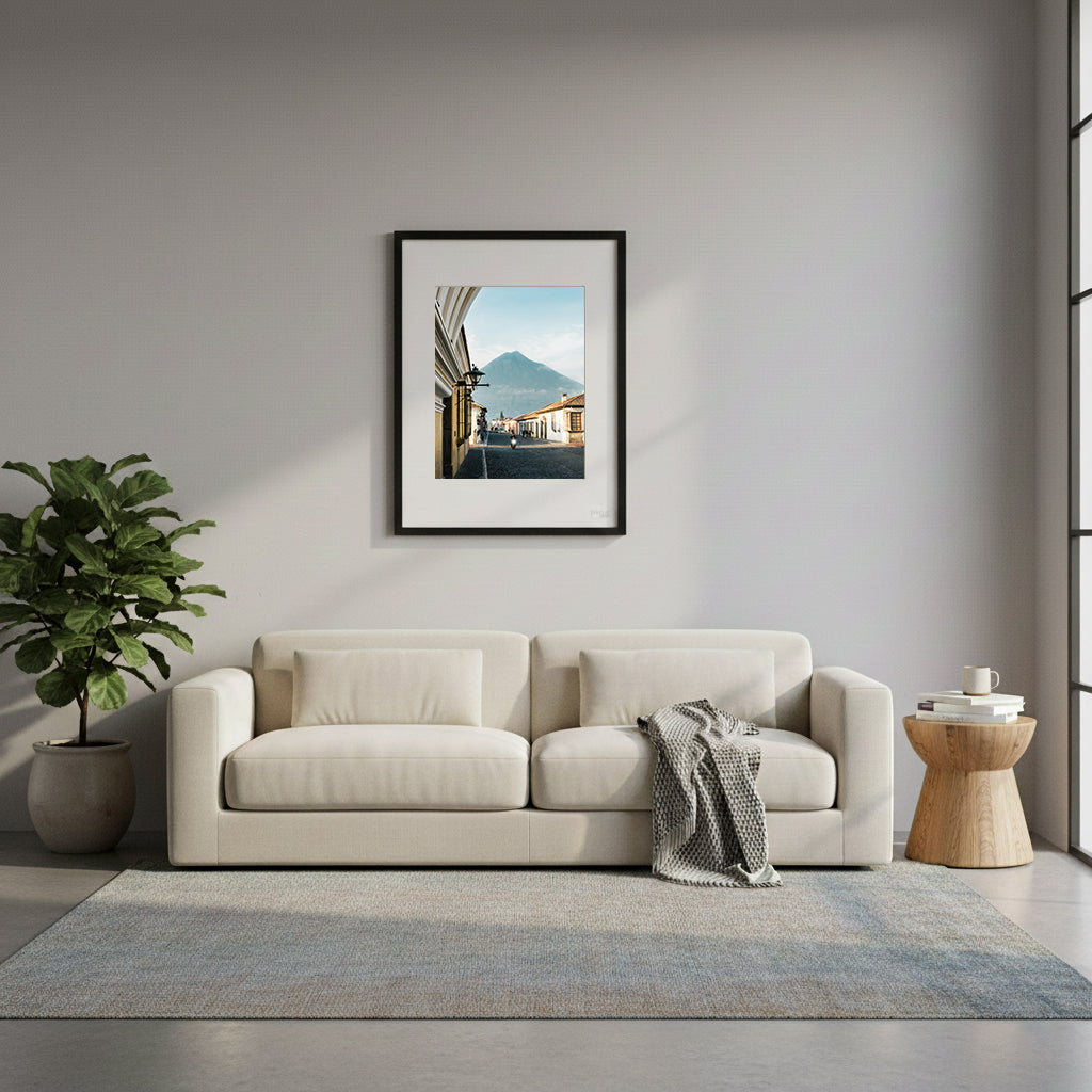 Framed cobbled street at dawn with buildings and a mountain in the background, Antigua, Guatemala.