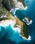 Aerial view of a tropical island with lush greenery and turquoise waters, Kellingking Beach, Bali, Indonesia.