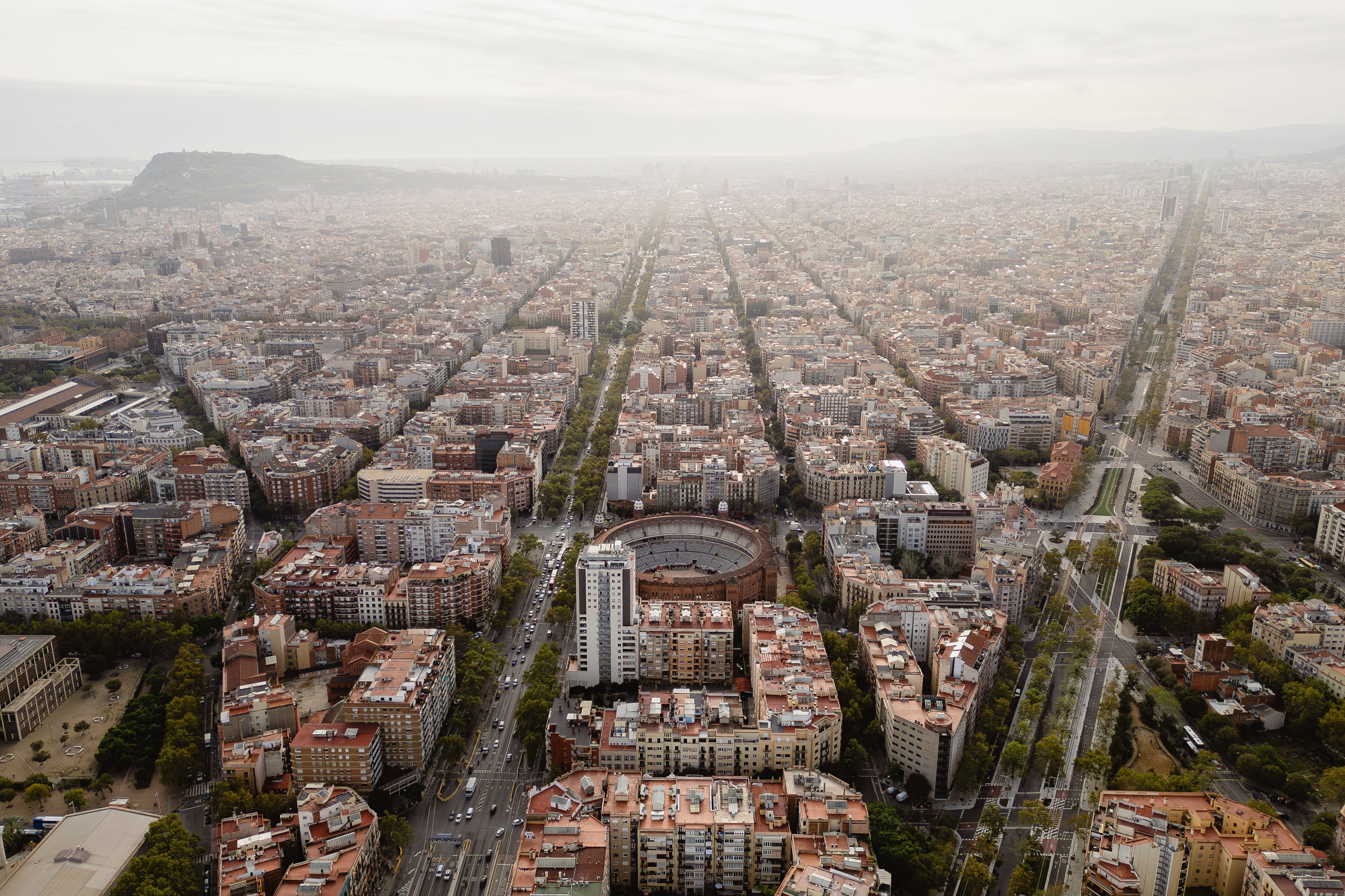 Aerial view of a city with buildings and roads on a foggy day