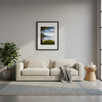 Framed beach scene with a person holding a surfboard, surrounded by greenery and clear sky in Noosa, Queensland, Australia. 