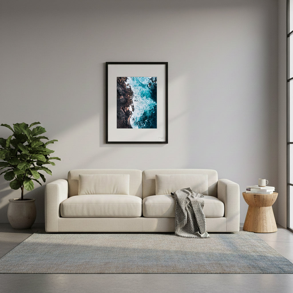 Framed turquoise ocean waves crashing against dark rocks in Cape Schank, Victoria, Australia.