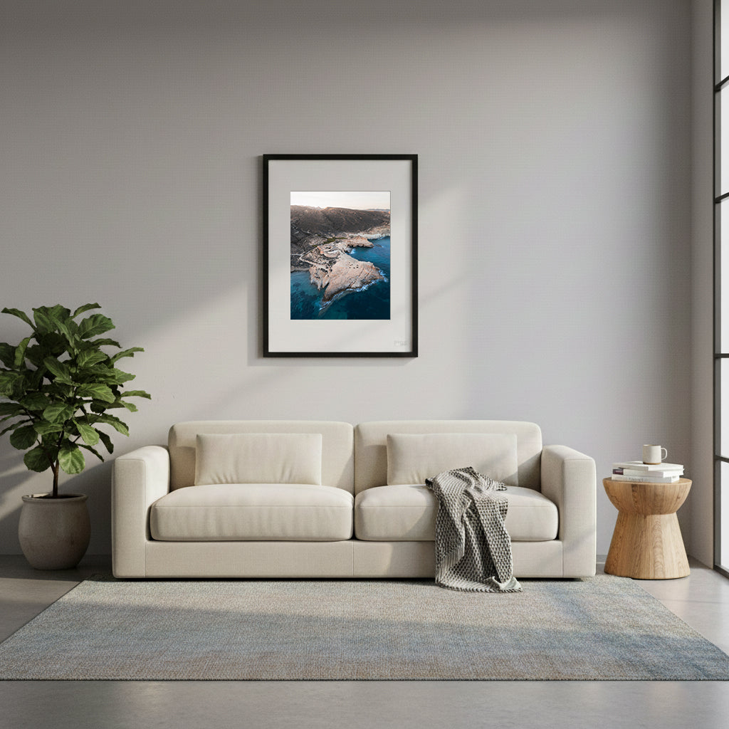 Framed rocky coastline with a fort-like structure surrounded by clear blue water, in Cabo de Gata, Spain.